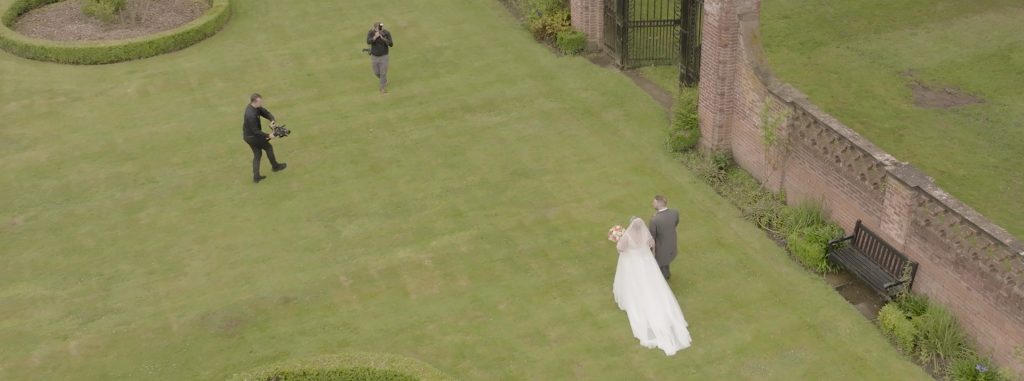 Videographer and photographer working well together as a team at wedding