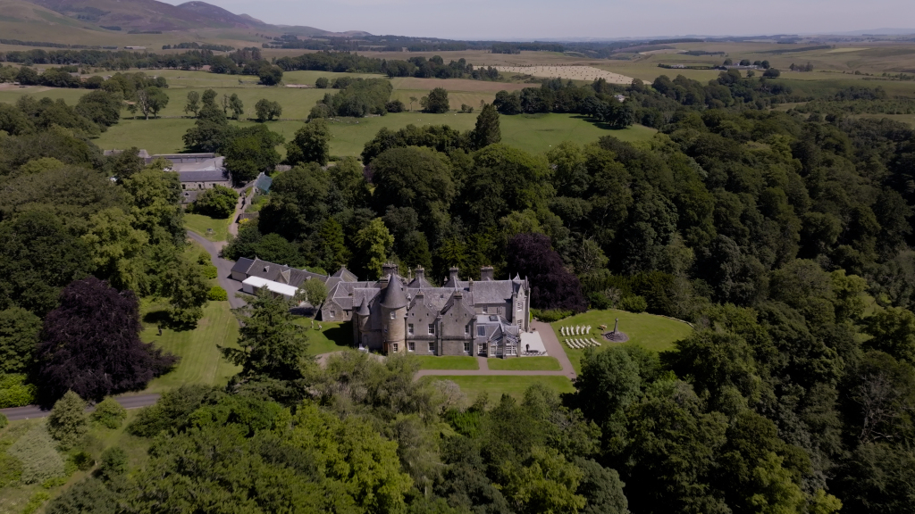 Drone creating an establishing shot of a Scottish Castle Wedding